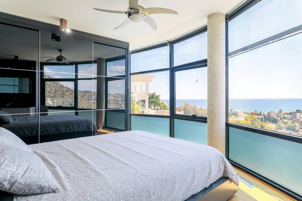 Modern villa with heated pool and spectacular panoramic views of the coast and sea, with rental licence