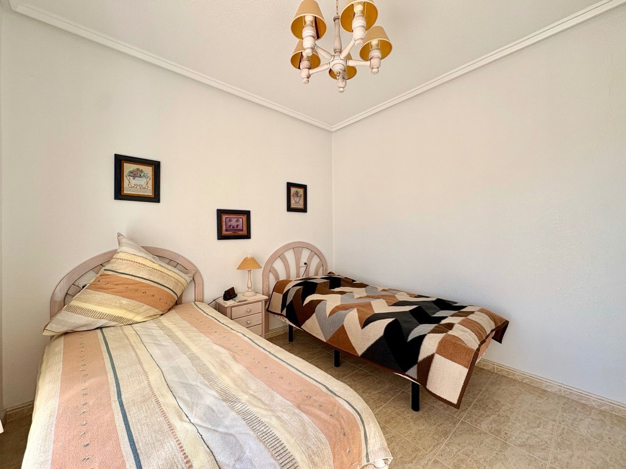 Two-bedroom terraced house with one bathroom, a guest toilet and a communal swimming pool in the La Fiesta II residential complex