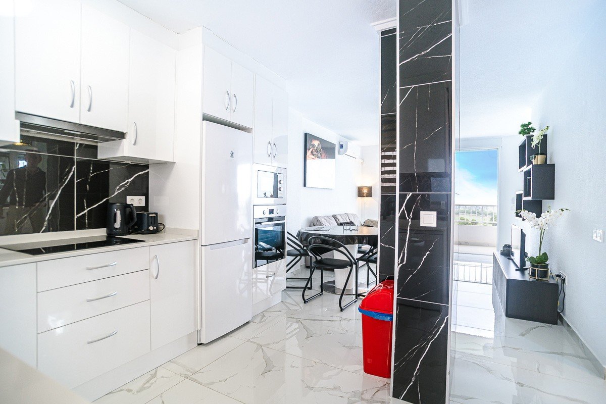 Beautifully renovated apartment with 2 bedrooms, 2 bathrooms, communal pool and sea views in Punta Prima just 300 meters from the sea