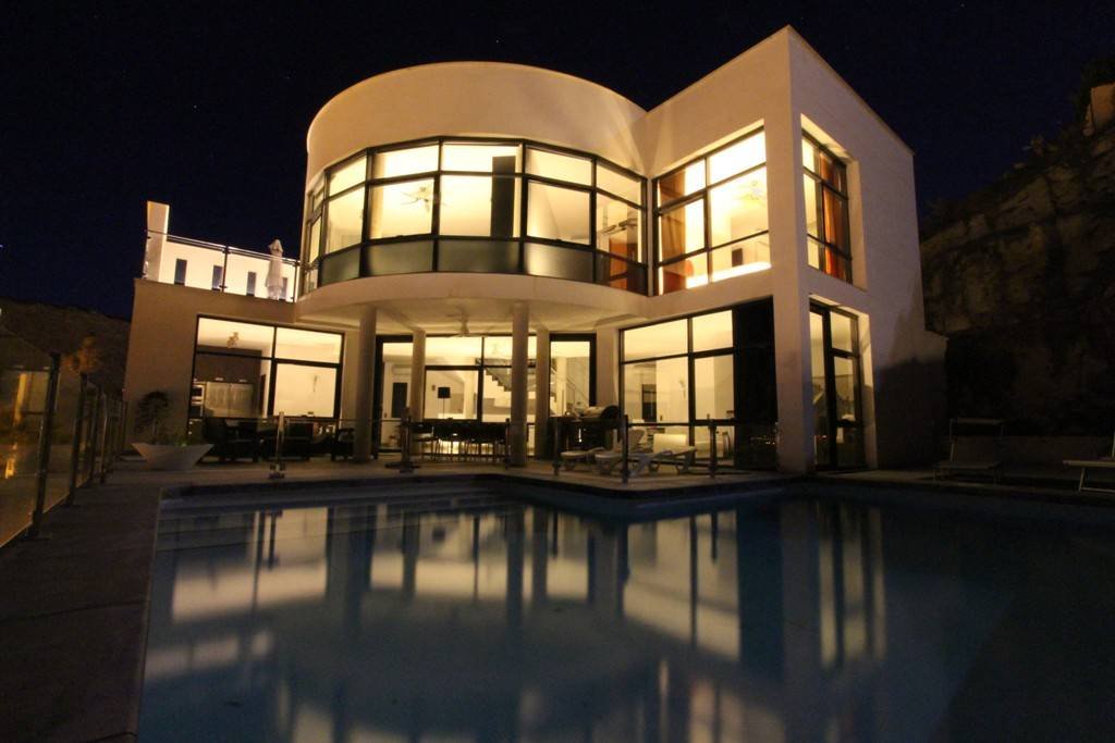 Modern villa with heated pool and spectacular panoramic views of the coast and sea, with rental licence